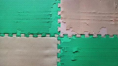 Worn out interlocking EVA foam puzzle play mat texture Stock Photos