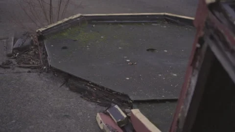A worn-out mini golf course at an abandoned site, featuring broken obstacles Stock Footage 337209349