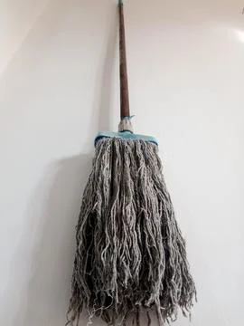Worn-Out Mop Still in Usable Condition on Floor 스톡 사진