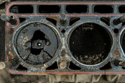 Worn out old engine with a broken piston in the cylinder. Close-up. Top view. Stock Photos