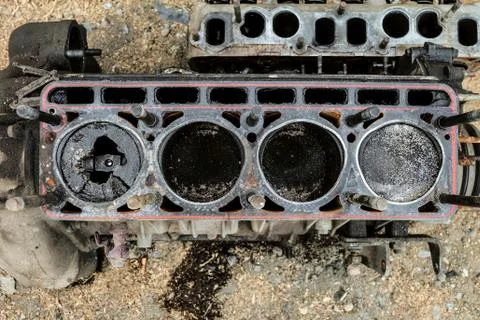 Worn out old engine with a broken piston in the cylinder. Top view. Stock Photos