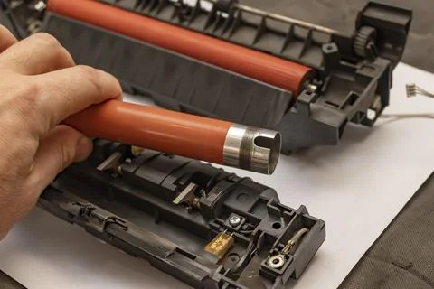 Worn out upper heating shaft, roller from a printer in the hand of a person Stock Photos