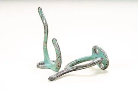 Worn painted wall hooks on a white background Foto stock