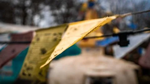 Worn prayer flags flutter gently in a breeze Fotos Stock