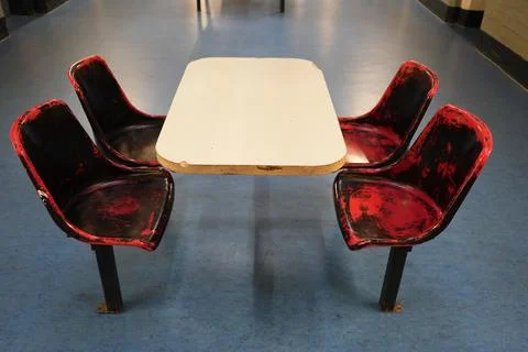 Worn Red And Black Table And Chairs At Shrewsbury Prison, Shropshire, England. Stock Photos