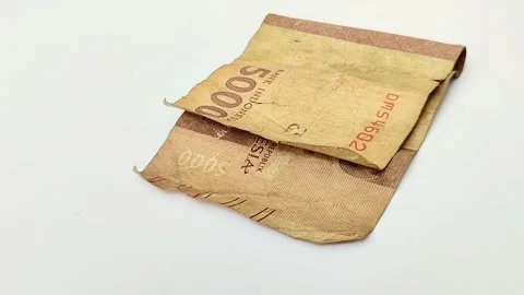 Worn rupiah banknotes on a white backgrou 스톡 동영상 315630138