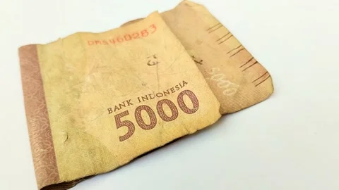 Worn rupiah banknotes on a white backgrou Stock Footage 315630139