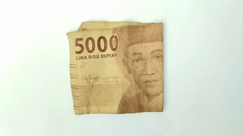 Worn rupiah banknotes on a white backgrou Stock Footage 315630147