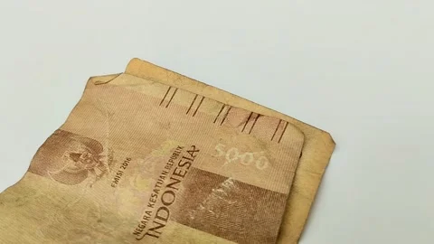 Worn rupiah banknotes on a white backgrou Stock Footage 315630214