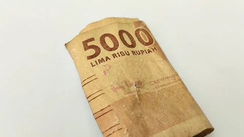 Worn rupiah banknotes on a white backgrou Stock Footage 315630215