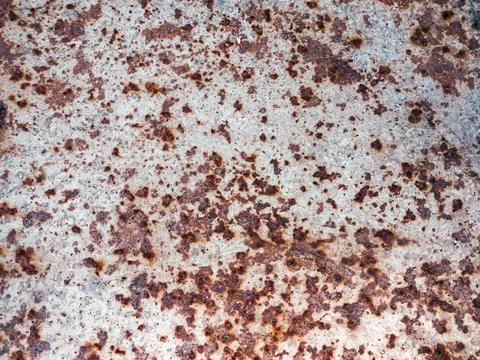 Worn rusty metal surface with cracking texture background. Stock Photos