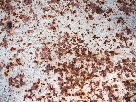 Worn rusty metal surface with cracking texture background. Stock Photos