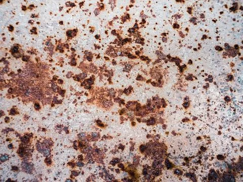 Worn rusty metal surface with cracking texture background. Stock Photos
