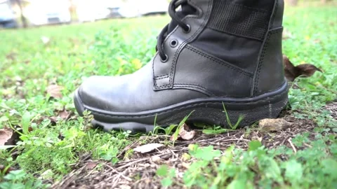 Worn soldier boot steps down on the earth Stock Footage 146466401