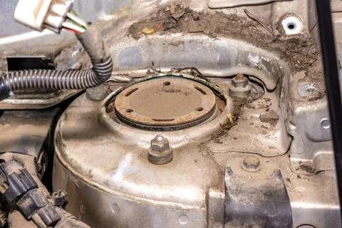 Worn strut mount causing noise and vibration during driving on uneven surfaces Stock Photos