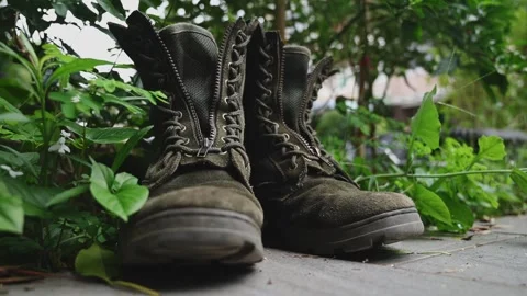 Worn Taiwanese Military Boots on Grass with Weathered Texture Stock Footage 345341753