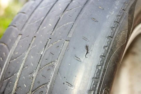 Worn Tire with Cut from Sharp Rock Impact Stock Photos