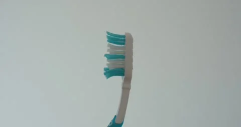 Worn Toothbrush Close-Up on White Background Stock Footage 337447935