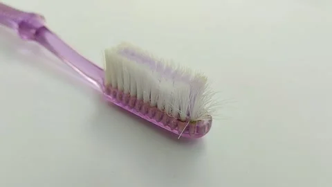 Worn toothbrush on white background 스톡 동영상 311303431