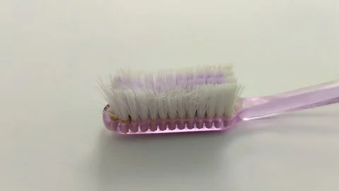 Worn toothbrush on white background Video stock 311303627