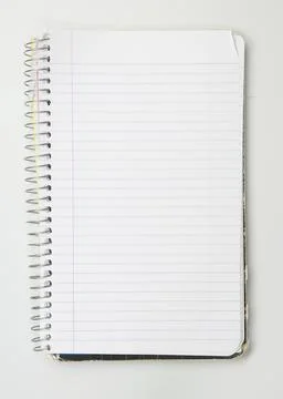 A worn used wire bound notebook opened to a blank lined page Stock Photos