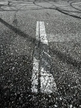 Worn white line divides asphalt surface Stock Photos