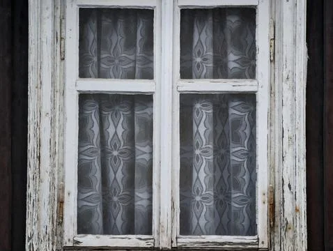 Worn wooden window with patterned lace curtains Stock Photos