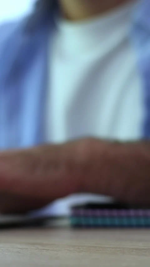 Worried and anxious man tapping his fingers on a wooden table, a gesture Stock Footage 345123908