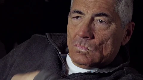 Worried and sad mid aged man sitting alone in the darkness Video stock 74431076
