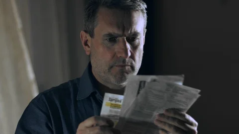 Worried and stressed man looking at bills Stock Footage 105931023