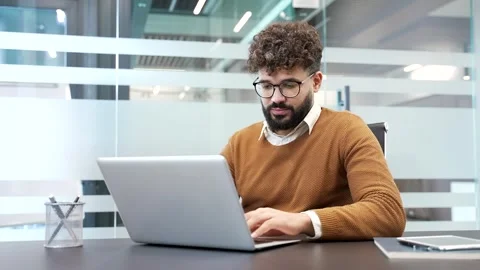 Worried businessman having difficulty making transaction using laptop while  Stock Footage 321820854