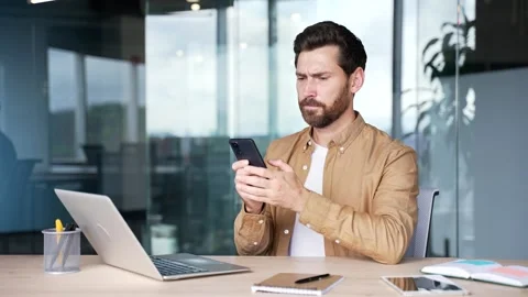 Worried businessman having problems with software or service on mobile phone  Stock Footage 295039151