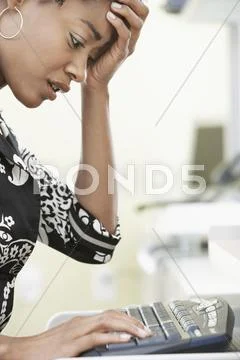 Worried Businesswoman Typing On Computer Keyboard Stock Photos