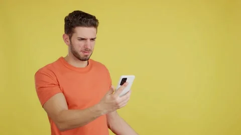 Worried caucasian man using a mobile phone Stock Footage 236419301