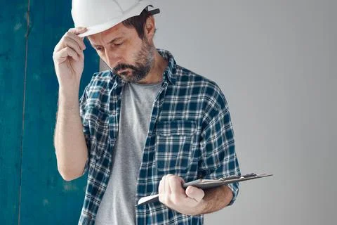 Worried construction engineer project manager after reviewing notes Stock Photos