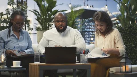 Worried coworkers react with shock to falling performance metrics during meeting Фото