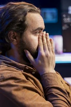 Worried developer distressed by cyber attacks on computer systems Stock Photos