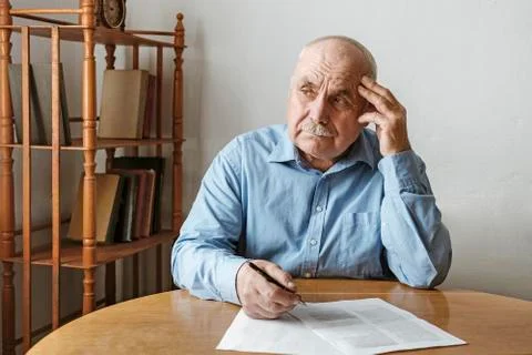 Worried elderly man completing a form 스톡 사진