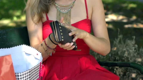 Worried girl looking on her empty purse after shopping, slow motion shot Stock Footage