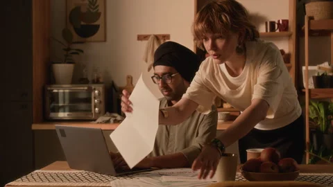 Worried Lady Helping Husband While Paying Utility Bills Online on Laptop Stock Footage 295149207
