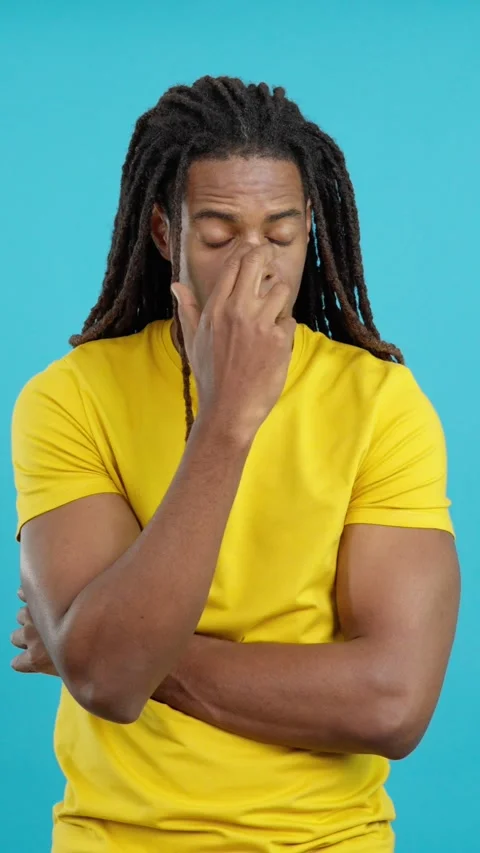 Worried latin man with dreadlocks looking up with pensive expression Stock Footage 254325587
