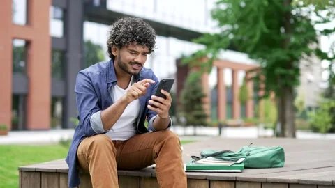 Worried male student having problems with software or service on mobile phone  Stock Footage 302472074