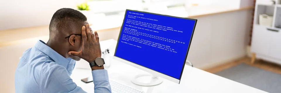 Worried Man At Computer With System Failure On The Screen Stock Photos