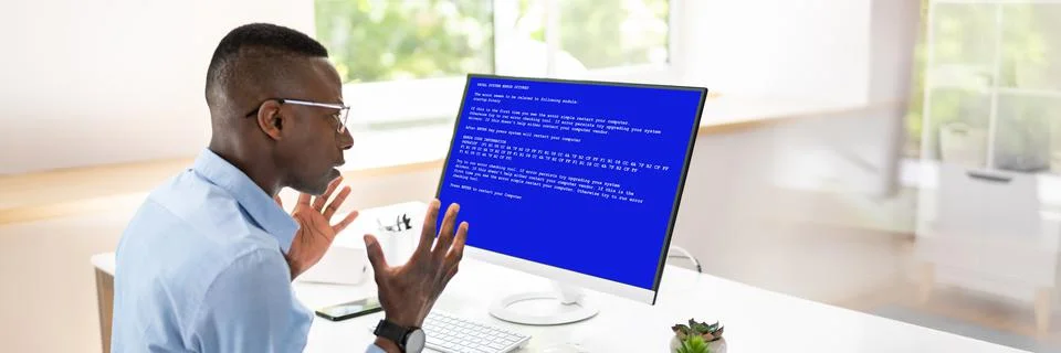 Worried Man At Computer With System Failure On The Screen Stock Photos