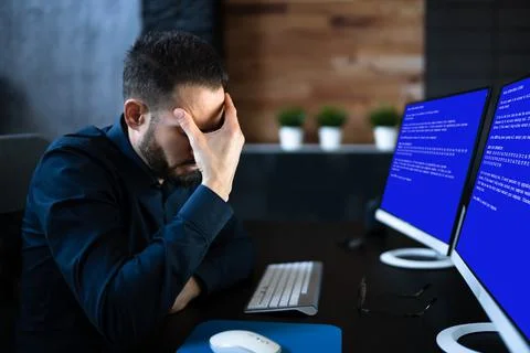 Worried Man At Computer With System Failure Screen Stock Photos