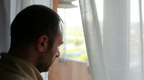 Worried man near window Stock Footage