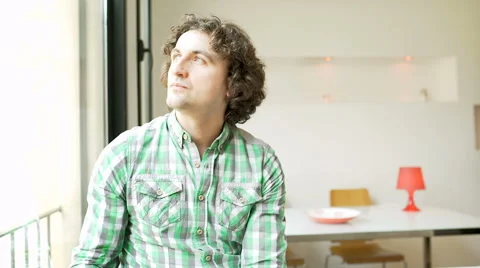 Worried man standing in the flat and thinking, steadycam shot 스톡 동영상 62975660