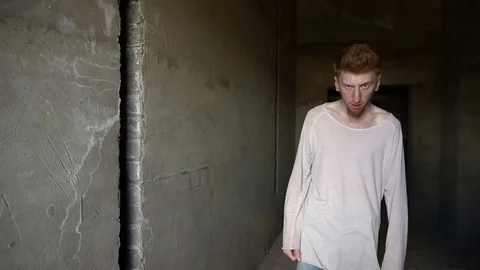 Worried man standing next to the gray concrete wall Stock Footage 76445835