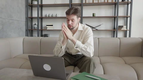 Worried Man Thinking And Looking At Laptop While Sitting On Sofa At Home Stock Footage 331793176