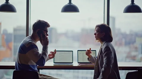 Worried managers calling smartphone having problems glass walls office closeup Stock Footage 335244467